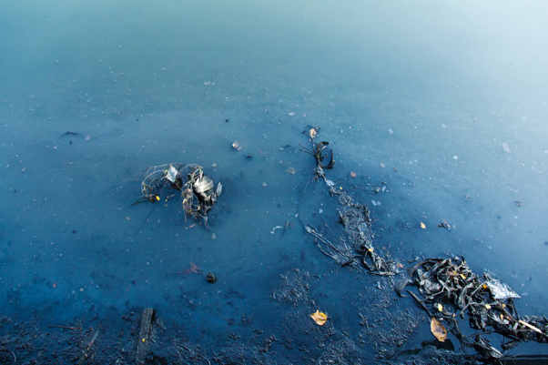 Polluted water containing waste and debris representing sewage pollution water caused by storm overflow discharges.